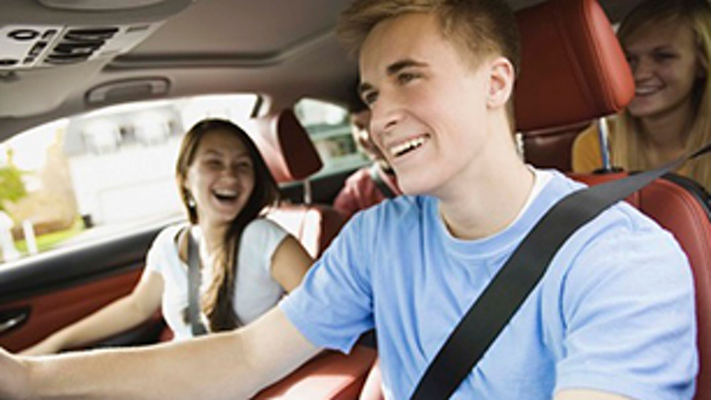 Smiling teenagers in a car