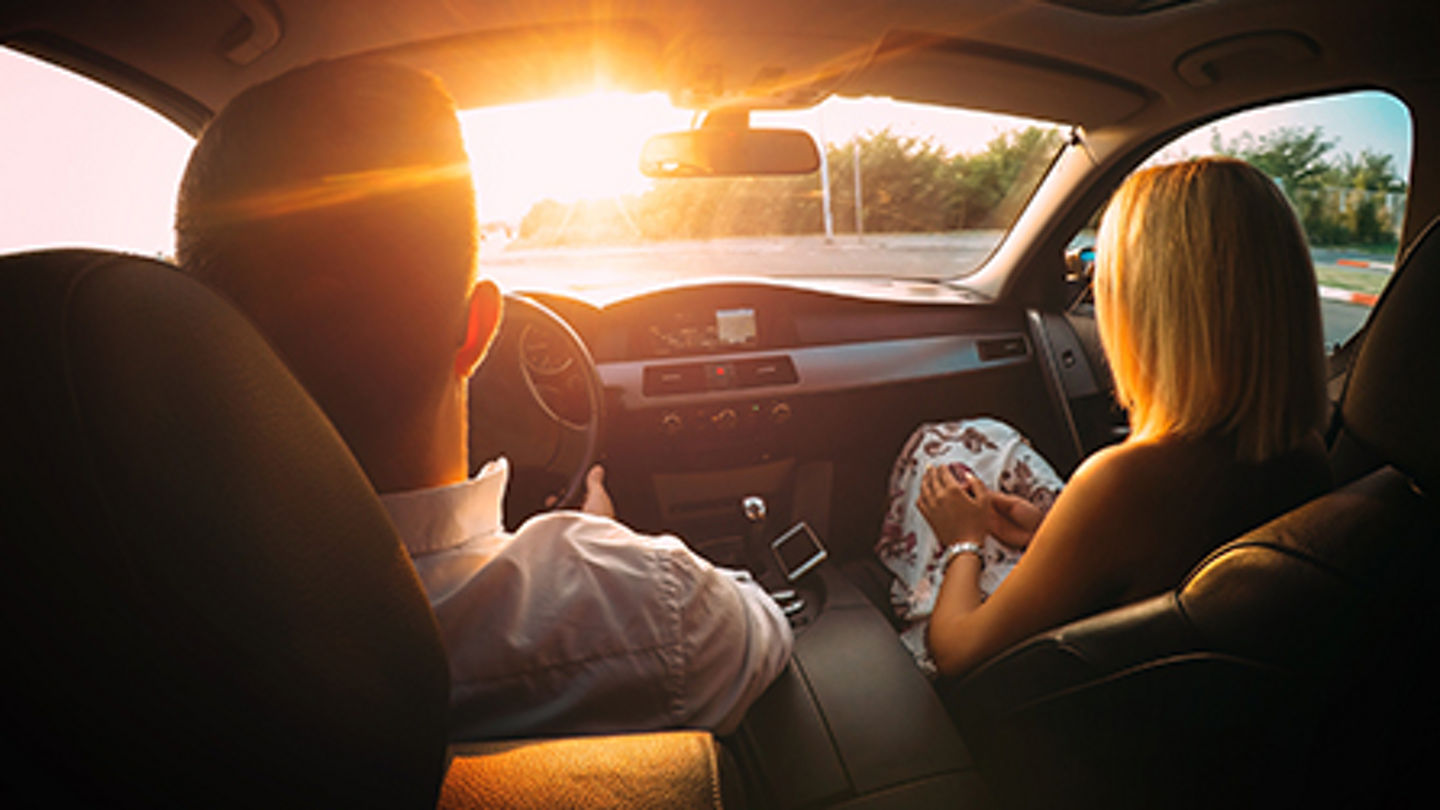 Young couple in a car on the road.