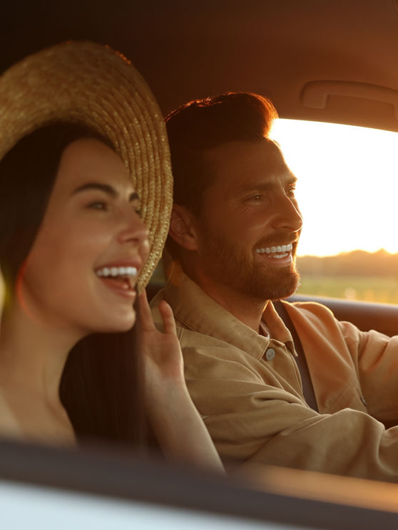 Happy couple enjoying trip together by car, selective focus