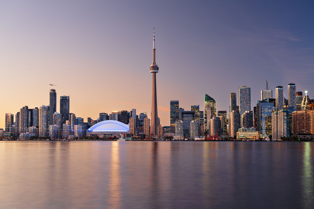 Toronto, Ontario, Canada downtown city skyline on Lake Ontario at twilight.
