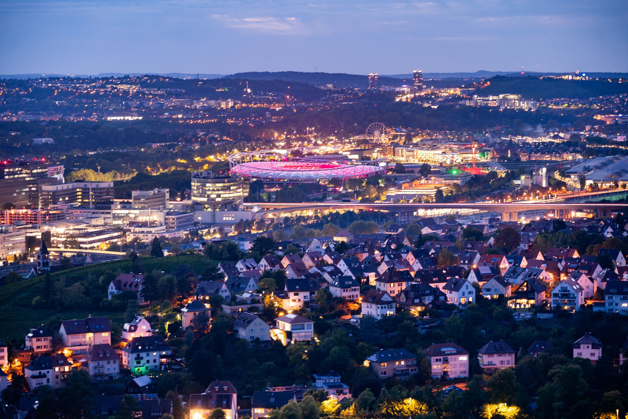 Stuttgart cityscape with illuminated Mercedes-Benz Arena at dusk